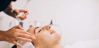 Cosmetologist applying product on woman’s face