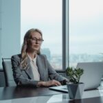 Sharply dressed real estate investor using her laptop to explore business opportunities