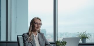 Sharply dressed real estate investor using her laptop to explore business opportunities